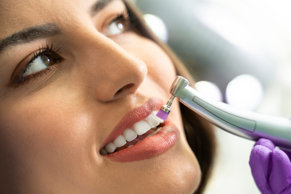 A woman having her teeth polished at the dentist.